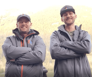 Jeffrey Scott Futrell and Nick Smith wearing grey Log Masters caps and jackets.