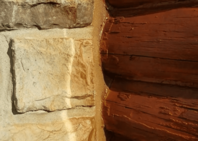 They didn’t adequately protect the stonework near the logs before staining.