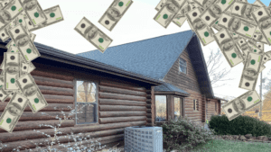 Brown log cabin with a dark roof, surrounded by falling $100 bills.