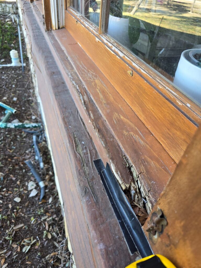 Obvious signs of damage to cabin exterior near window, causing wind, rain, and insects to enter the rental cabin