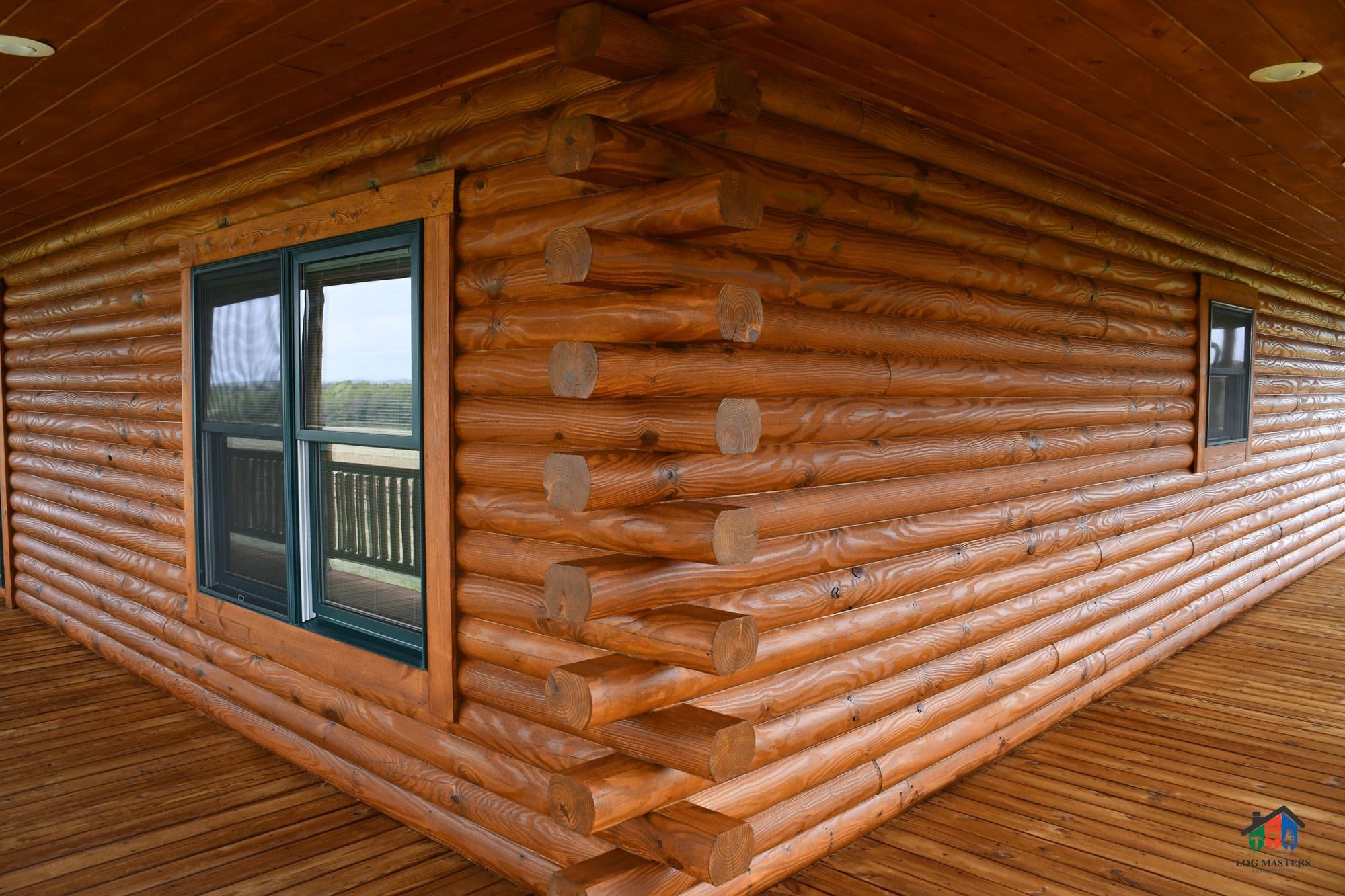 The image is a close up of tan chink lines on a round log cabin.