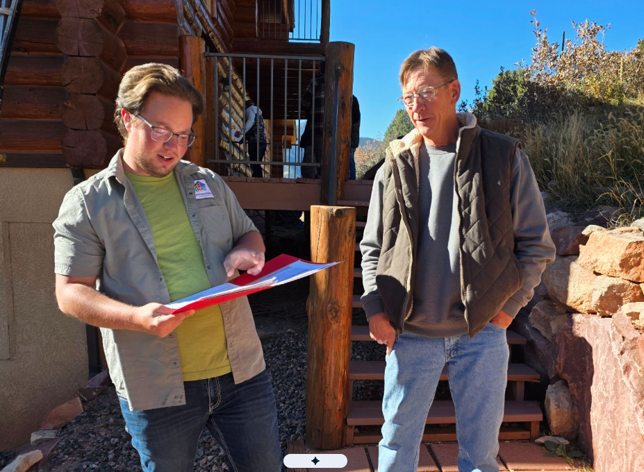 Log Masters Project Manager Talking to Log Home Resident