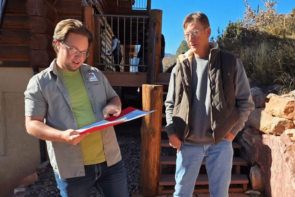 Log Masters Project Manager Talking to Log Home Resident
